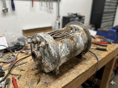Corroded and broken heater coil showing scale buildup damage